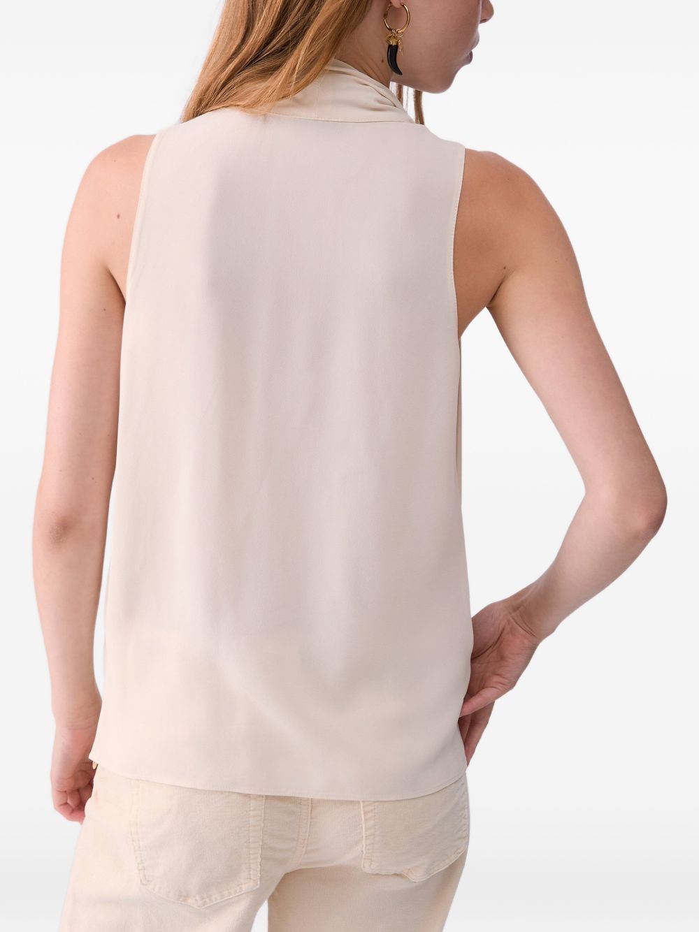 LIUJO Top color crema senza maniche con collo lavallière e frange